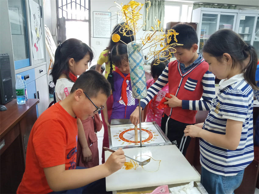 成都市回民小學(xué)學(xué)生學(xué)習(xí)糖畫，感受民俗文化。成都市民宗局供圖